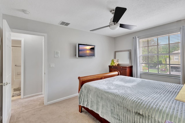 carpeted bedroom featuring a textured ceiling and ceiling fan