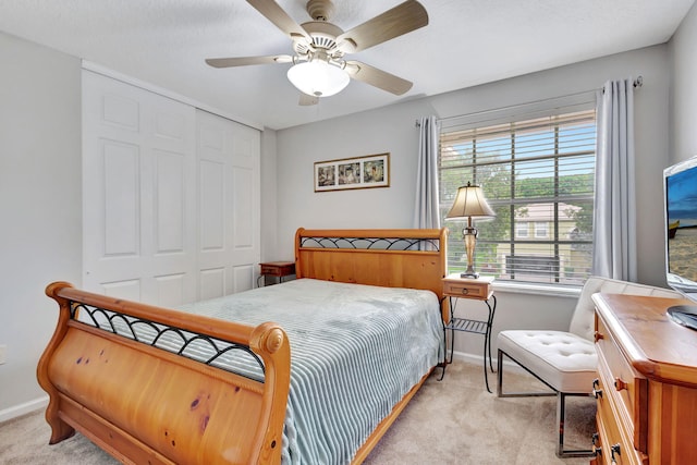 8951 Alexandra Cir, Wellington, FL 33414 - bedroom with light carpet, baseboards, a closet, and a ceiling fan