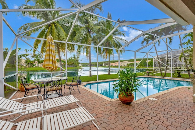 view of swimming pool featuring a patio, a water view, and a lanai