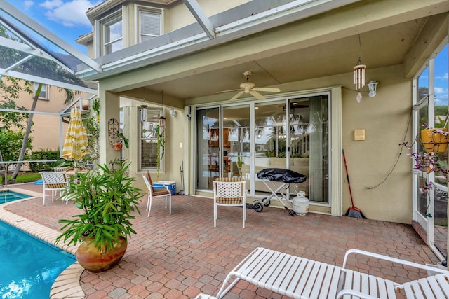 view of patio / terrace featuring ceiling fan and a lanai