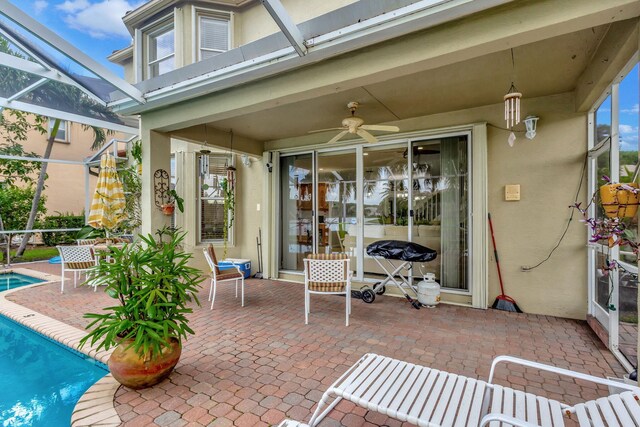 8951 Alexandra Cir, Wellington, FL 33414 - view of patio with glass enclosure, an outdoor pool, and a ceiling fan