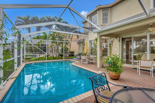 view of pool featuring a patio, a lanai, and ceiling fan