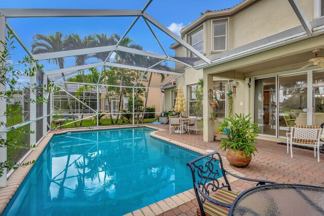 8951 Alexandra Cir, Wellington, FL 33414 - outdoor pool with a patio area and a lanai