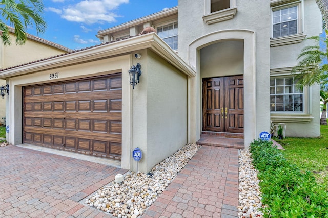 view of exterior entry featuring a garage