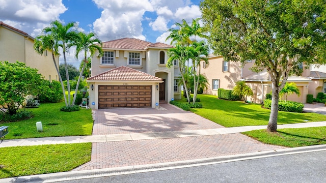 8951 Alexandra Cir, Wellington, FL 33414 - mediterranean / spanish house with stucco siding, a tile roof, driveway, a front yard, and a garage