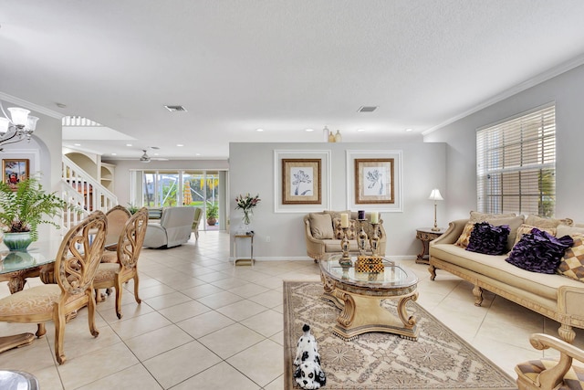 tiled living room with ornamental molding and a chandelier