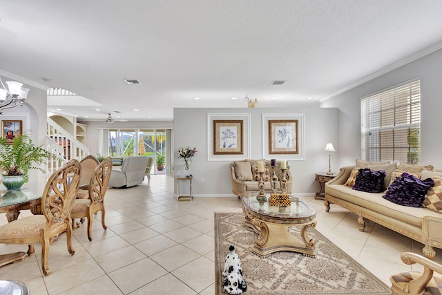 8951 Alexandra Cir, Wellington, FL 33414 - living room featuring light tile patterned floors, stairs, crown molding, a chandelier, and baseboards