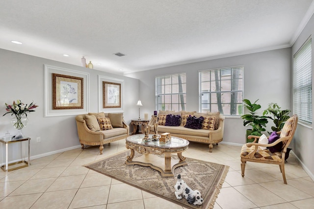 tiled living room with ornamental molding and a textured ceiling