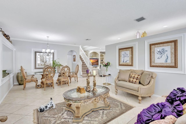 tiled living room with a notable chandelier, ornamental molding, and built in features