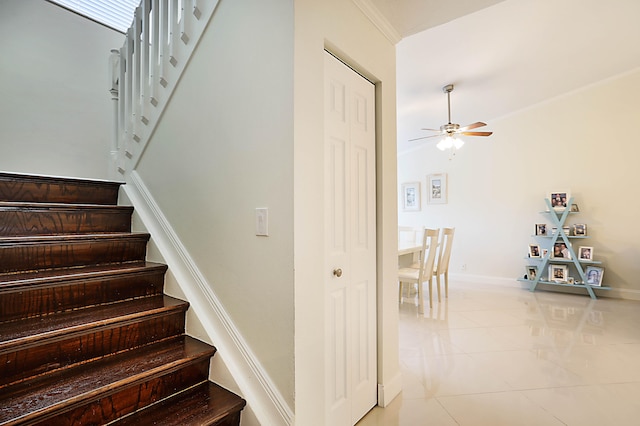 stairway with tile patterned flooring and ceiling fan