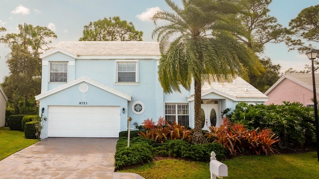 view of front of property featuring a garage and a front yard