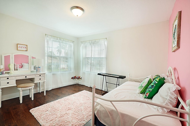 bedroom with dark hardwood / wood-style floors