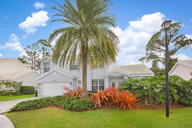 view of front of house with a garage and a front lawn