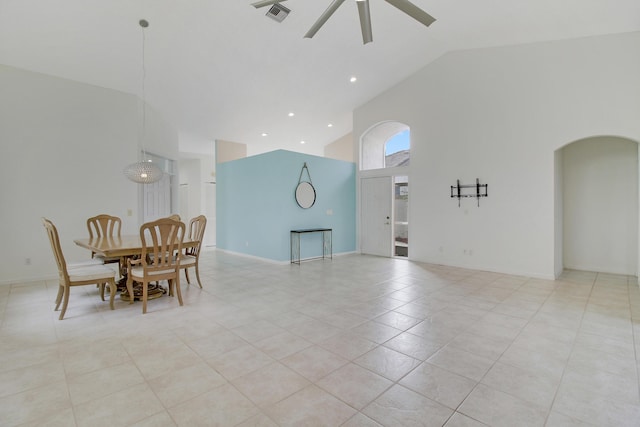 dining room featuring light tile patterned floors, high vaulted ceiling, and ceiling fan