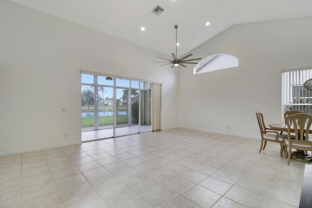 interior space featuring ceiling fan, high vaulted ceiling, and light tile patterned floors