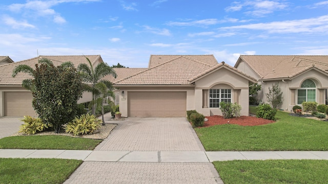 view of front of home with a garage and a front yard