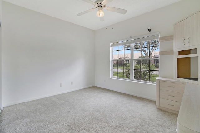 unfurnished bedroom featuring ceiling fan and light carpet