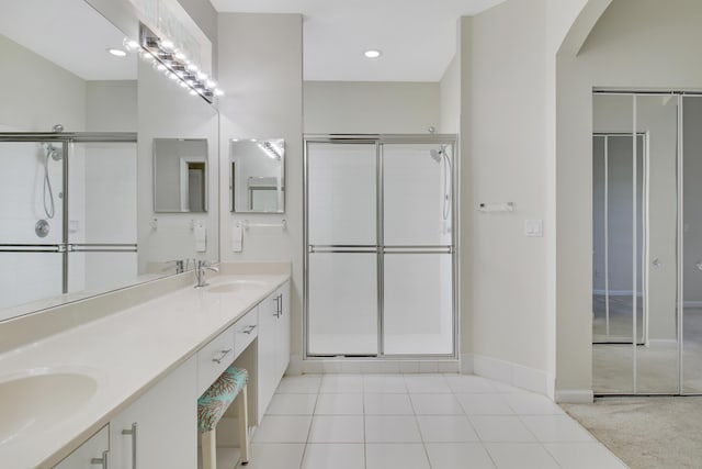 bathroom featuring vanity, tile patterned floors, and walk in shower