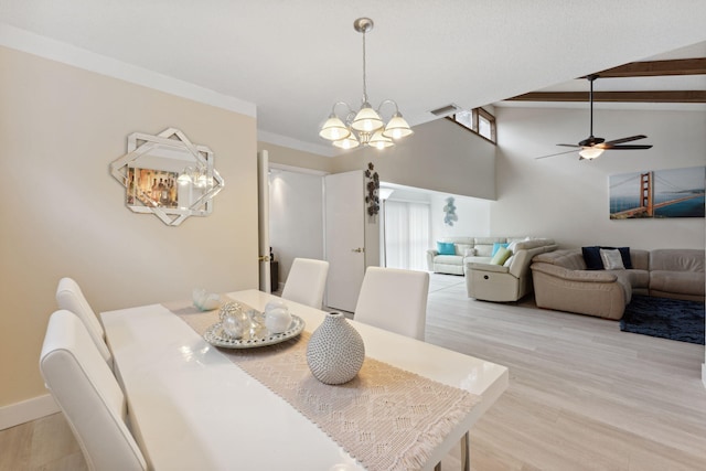 dining space featuring light hardwood / wood-style flooring, high vaulted ceiling, ceiling fan with notable chandelier, and crown molding