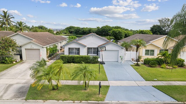 ranch-style house featuring a front yard and a garage