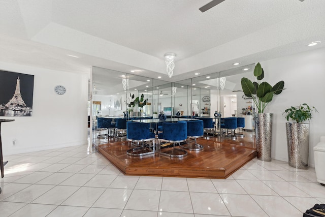 interior space featuring a textured ceiling and light tile patterned flooring