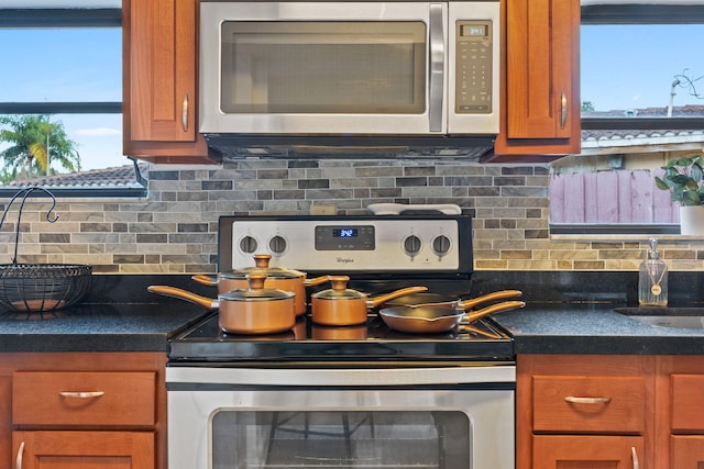 kitchen featuring stainless steel appliances and tasteful backsplash