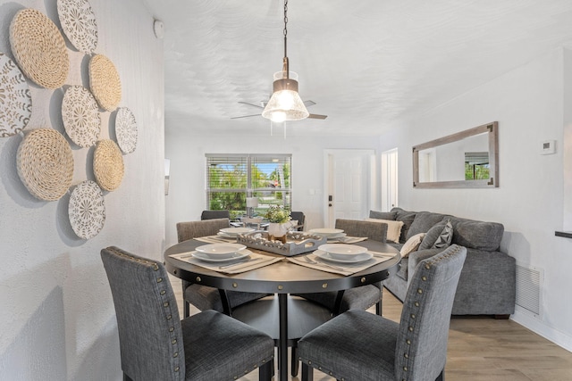 dining space featuring hardwood / wood-style floors and ceiling fan