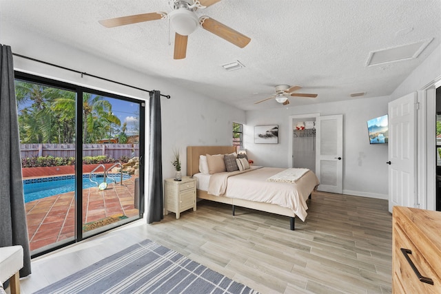 bedroom with light hardwood / wood-style floors, a textured ceiling, access to exterior, and ceiling fan