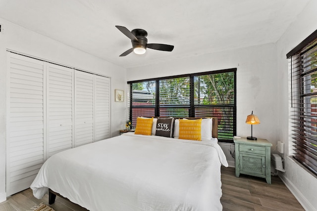 bedroom featuring a closet, ceiling fan, and dark hardwood / wood-style floors