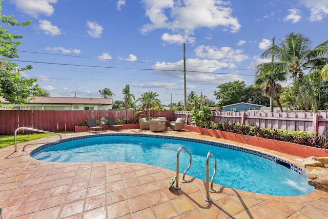 view of pool featuring a patio area, pool water feature, and an outdoor hangout area