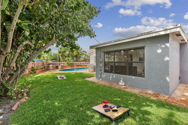 view of yard with a fenced in pool