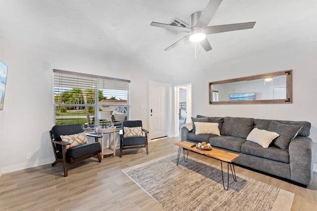 living room featuring light hardwood / wood-style flooring and ceiling fan