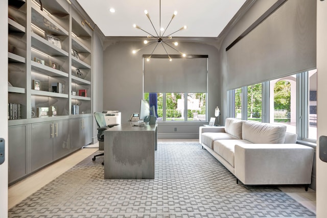 office featuring crown molding, hardwood / wood-style flooring, a notable chandelier, and a high ceiling