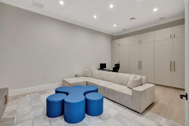 living room with ornamental molding and light hardwood / wood-style flooring