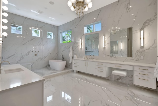 bathroom with tile walls, vanity, a chandelier, and separate shower and tub