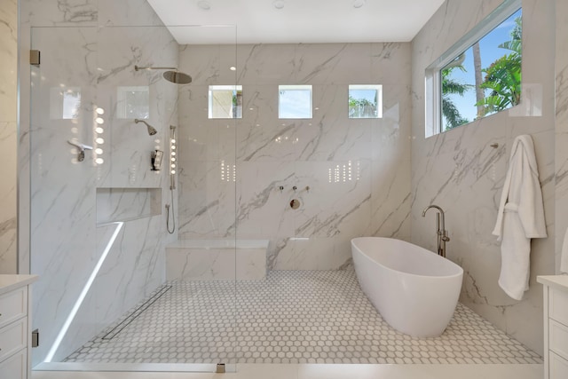 bathroom featuring vanity, plus walk in shower, and tile walls