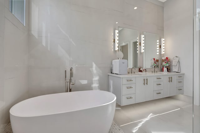 bathroom featuring tile walls, vanity, and a bathtub