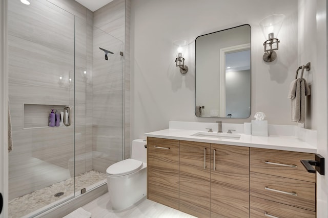 bathroom with toilet, a shower with shower door, and vanity