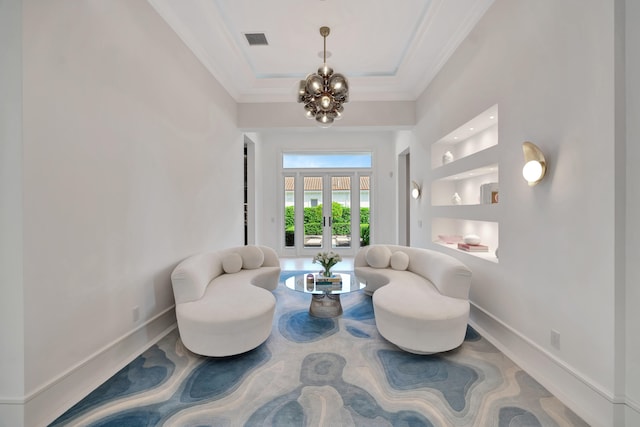 living area featuring crown molding, a notable chandelier, and built in features