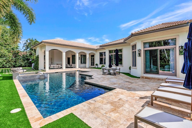 view of pool featuring a patio and an in ground hot tub