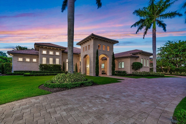 mediterranean / spanish-style home featuring a yard