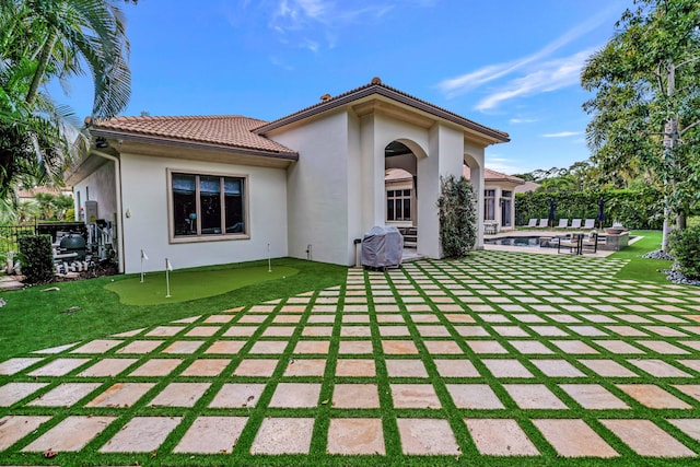 rear view of property featuring a patio area