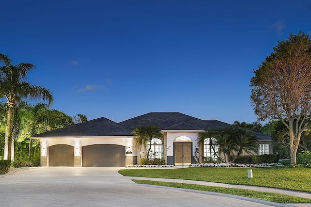 view of front of property featuring a garage and a front lawn