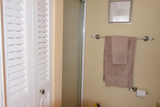 bathroom featuring a shower with door