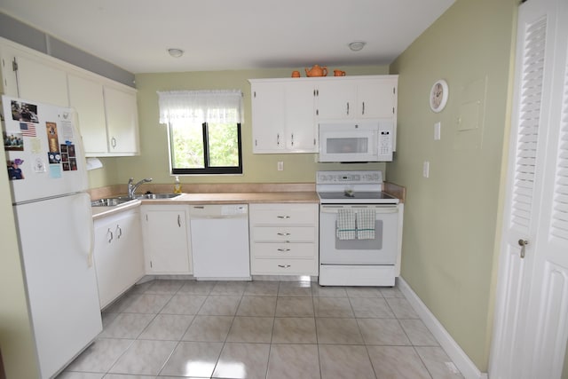 kitchen with white cabinetry, sink, white appliances, and light tile patterned floors