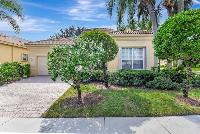 mediterranean / spanish-style home with a garage