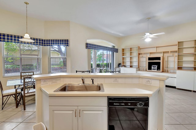 kitchen with hanging light fixtures, ceiling fan, light tile patterned floors, dishwasher, and sink