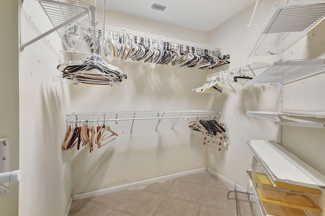 spacious closet featuring light tile patterned floors