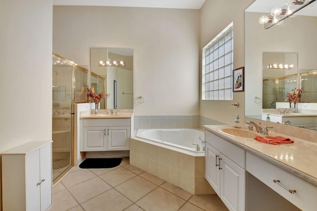 bathroom featuring vanity, shower with separate bathtub, and tile patterned flooring