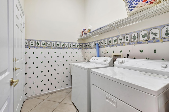 laundry area featuring washer and dryer and light tile patterned floors